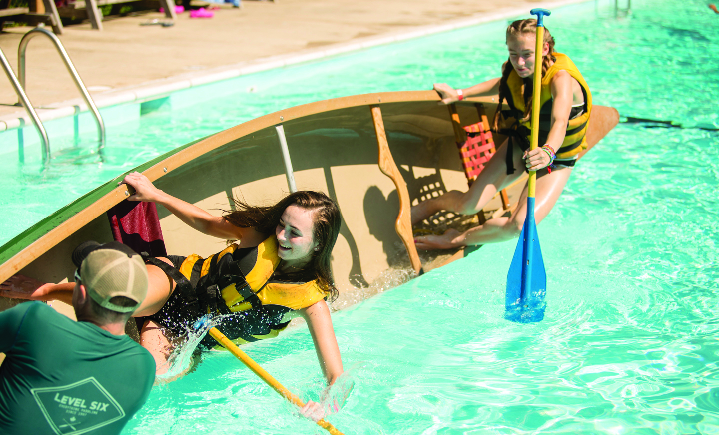 two campers practice canoe safety in the pool at Manidokan Camp and Retreat Center before hitting the river.