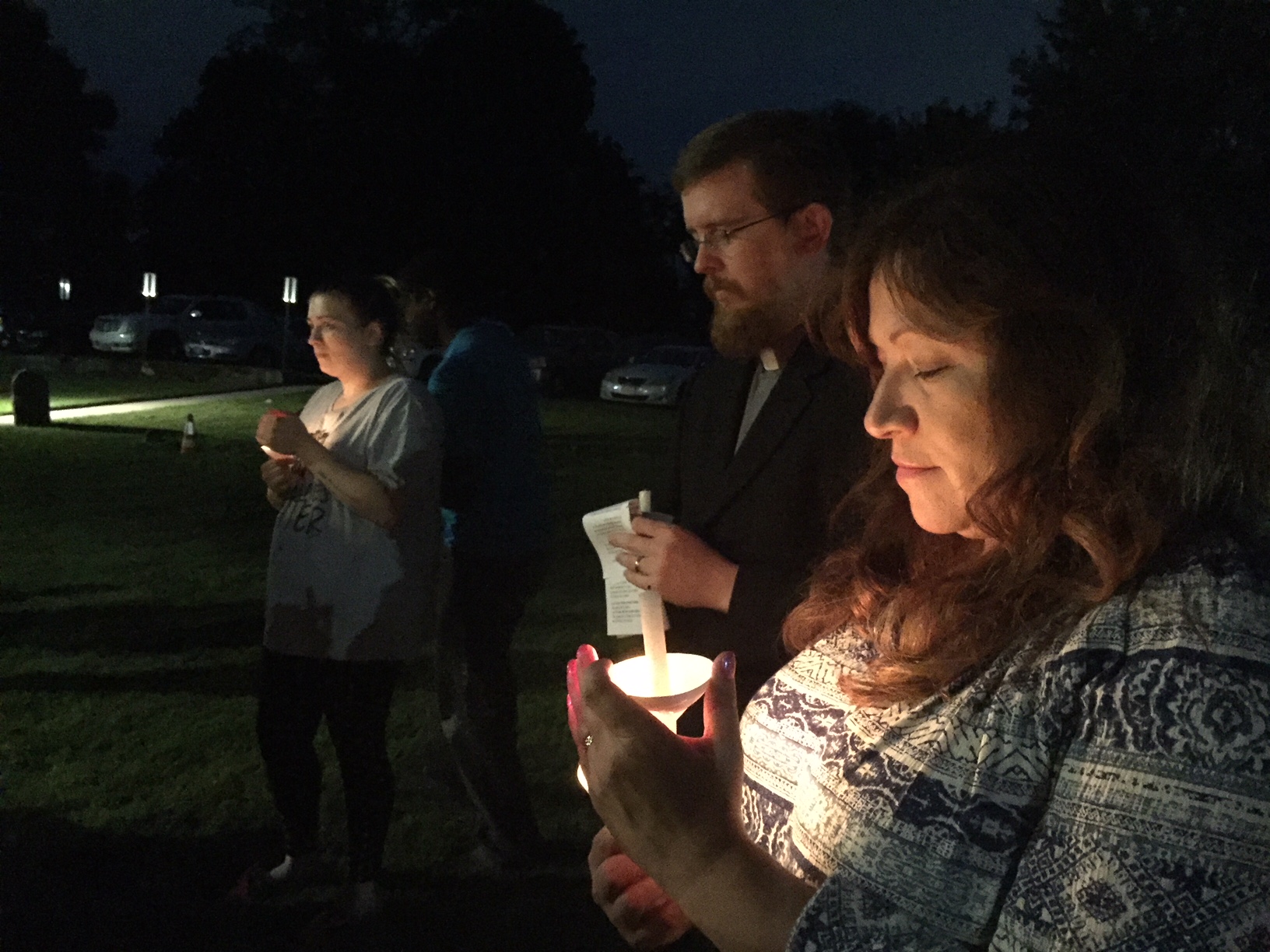 Linda Midwig, far right, stands with the Rev. Mark Gorman during a prayer vigil Sept. 28 at Cranberry UMC in Perryman. Photo by Erik Alsgaard.