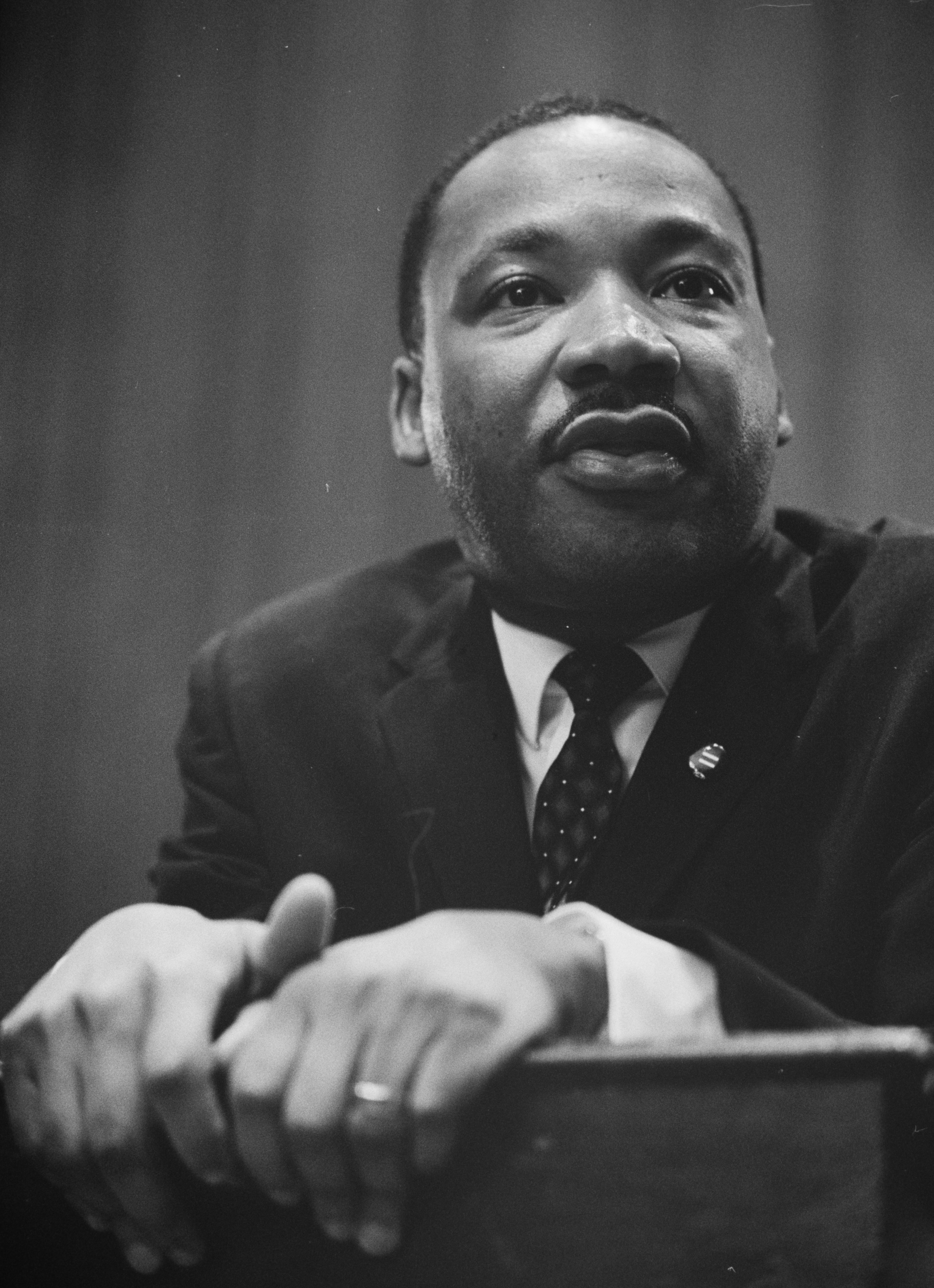 Martin Luther King leaning on a lectern