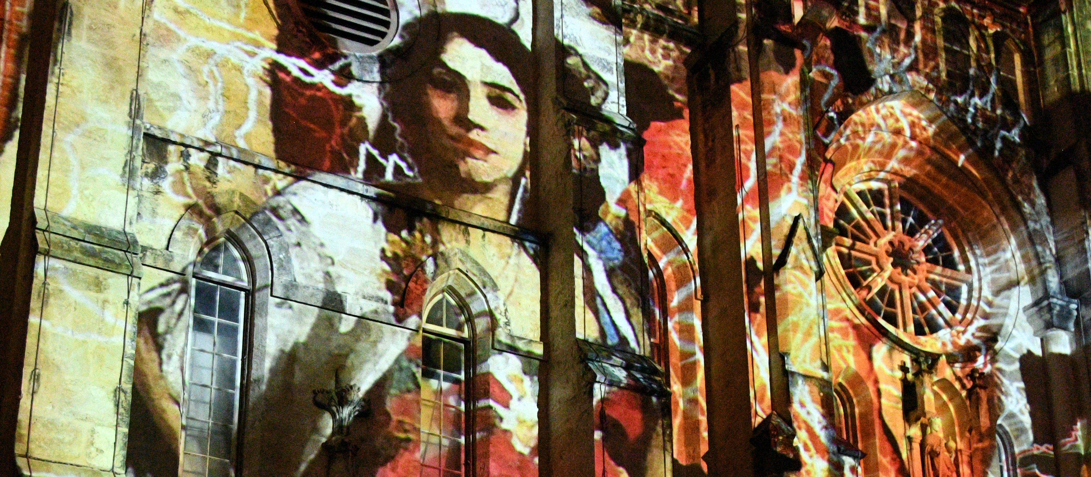 an image of a woman projected onto a church