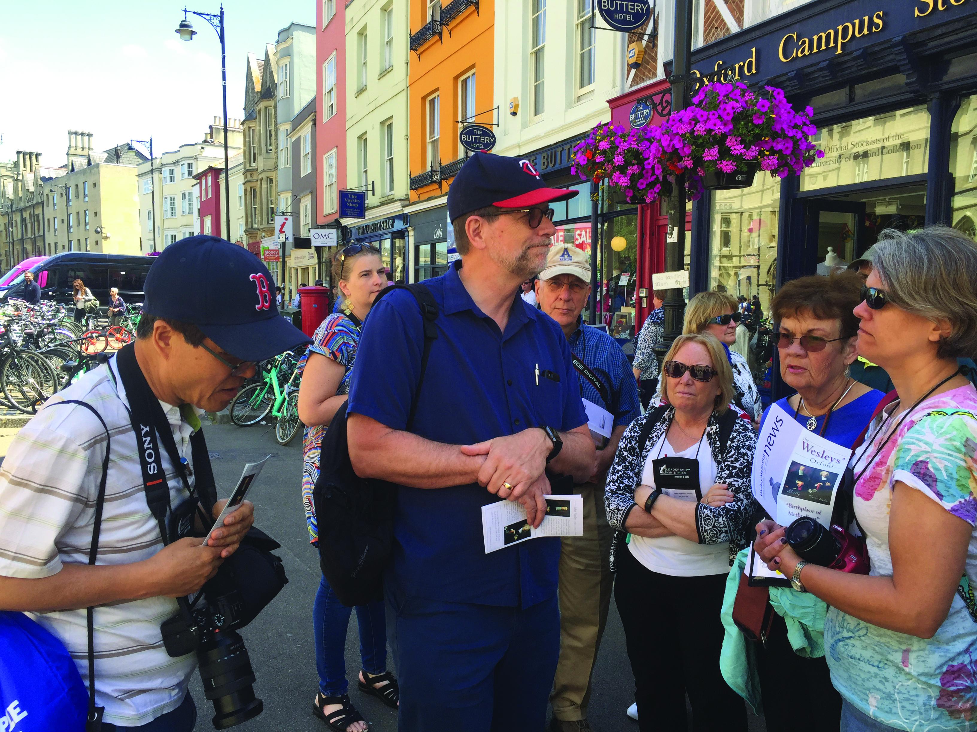 The Rev. Steve Manskar, center, leads a group of pilgrims through the streets of Oxford.