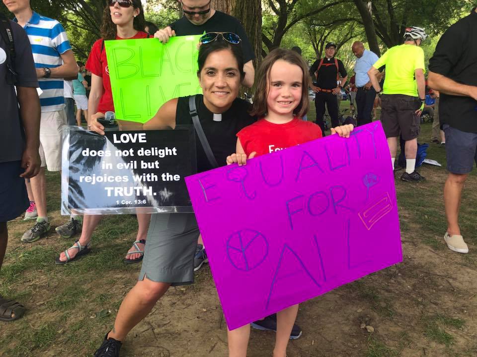 People holding up signs at the united to love rally